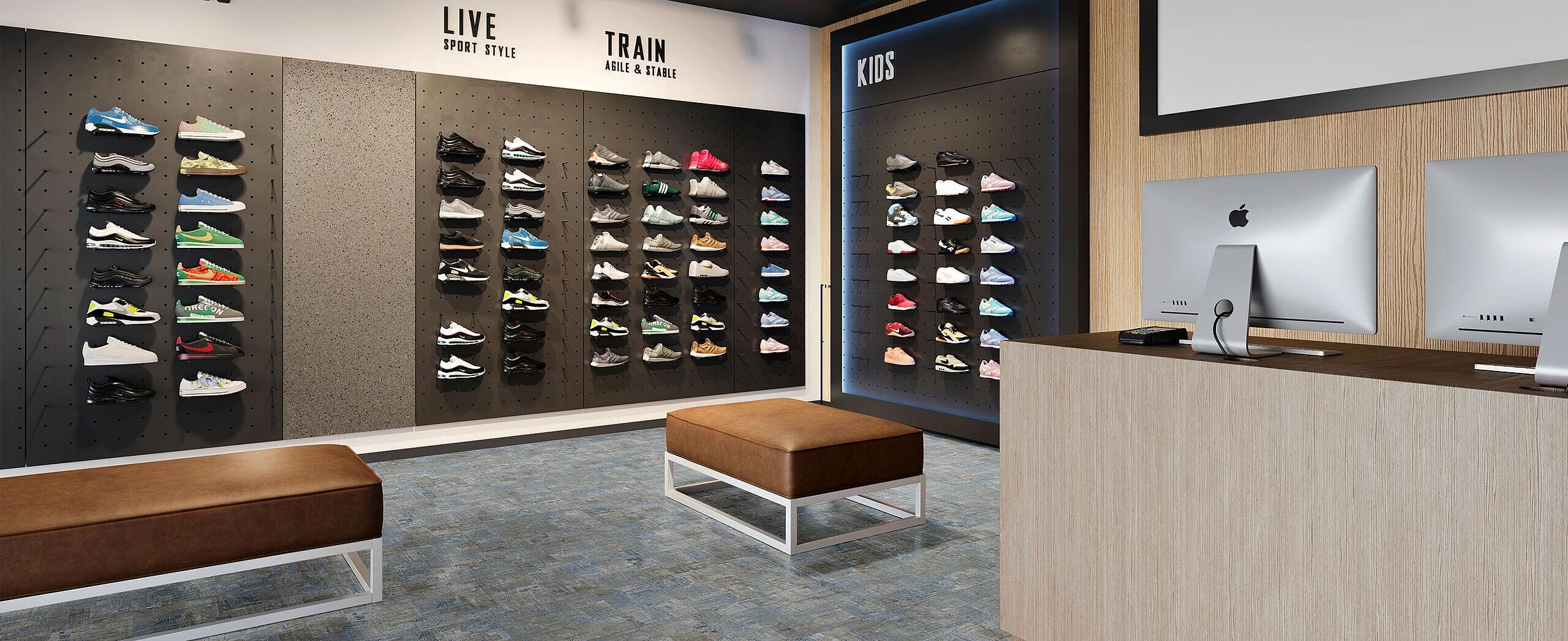 Modern sneaker store with shoe display wall and benches on recycled elastic flooring in a blue-grey stone look with a lively, mottled texture.