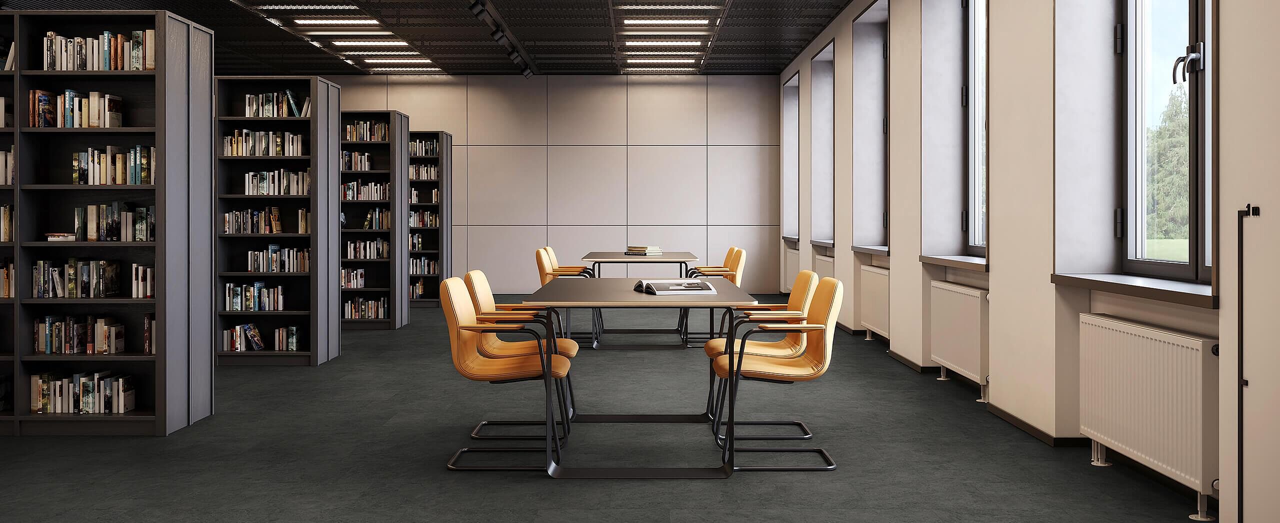 Library room with shelves and tables, yellow chairs on recycled elastic flooring in a dark grey stone-look design.
